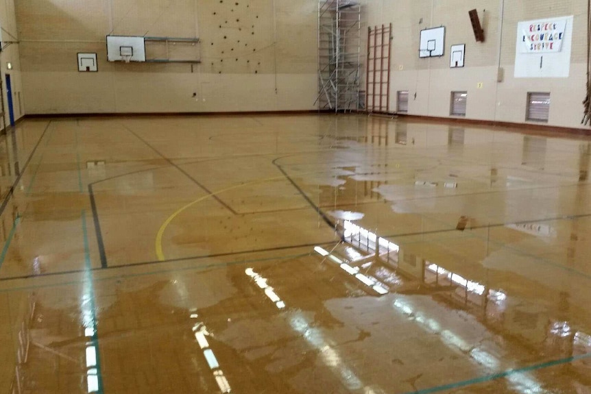 A school gymnasium with wet floor.