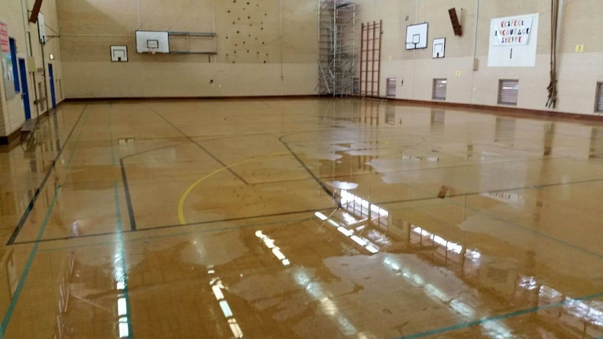 A school gymnasium with wet floor.