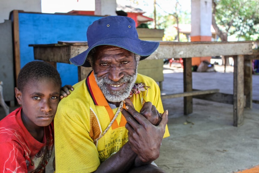 A man and child at Blackman Town markets on the island of Tanna in Vanuatu.