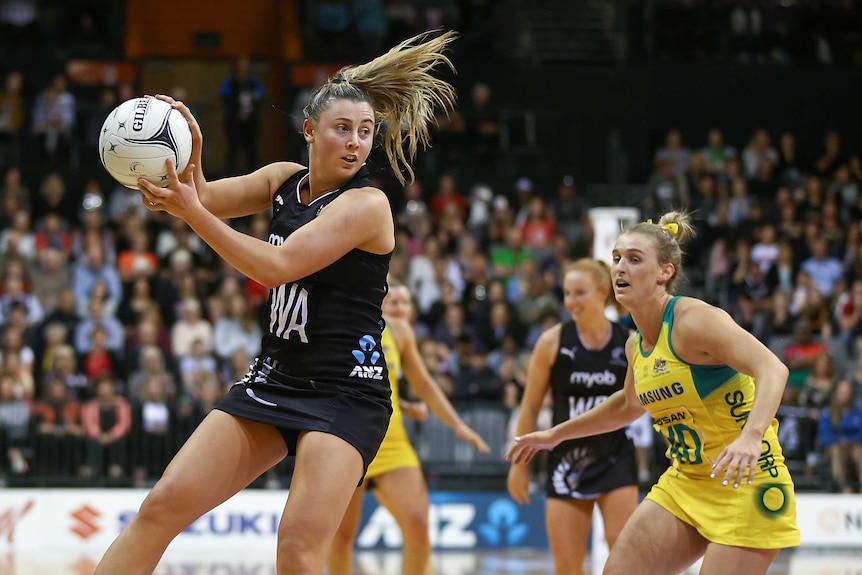 Gina Crampton jumps in the air to catch the ball for New Zealand against Australia in the third Constellation Cup Test.
