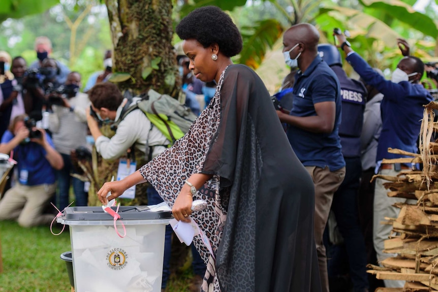 Uganda's leading opposition challenger Bobi Wine's wife, Barbie Kyagulanyi, casts her vote in an outdoor box in Kampala.