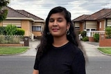 Swapna Karanam stands in a suburban driveway and looks into the camera.