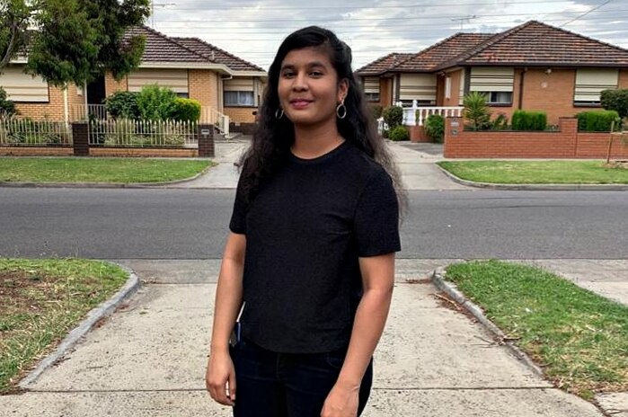 Swapna Karanam stands in a suburban driveway and looks into the camera.