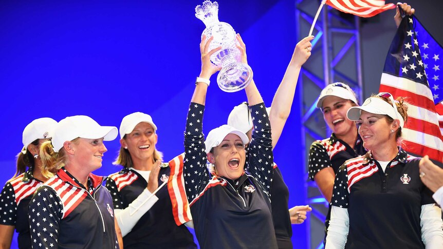 Team USA's Cristie Kerr holds the trophy after the US beat Europe in the Solheim Cup in Germany.