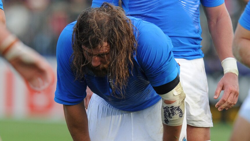 Italian rugby player with hands on knees at World Cup