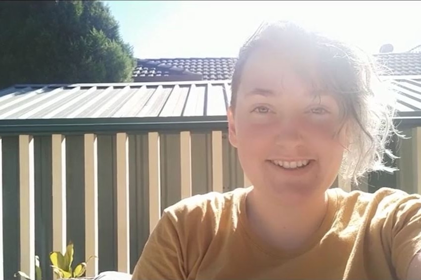 CourtneyJade smiling in the sunshine in a selfie video.