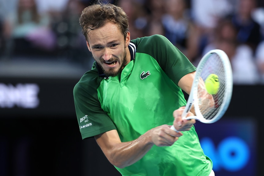 Daniil Medvedev plays a double-fisted backhand during 2024 Australian Open final.