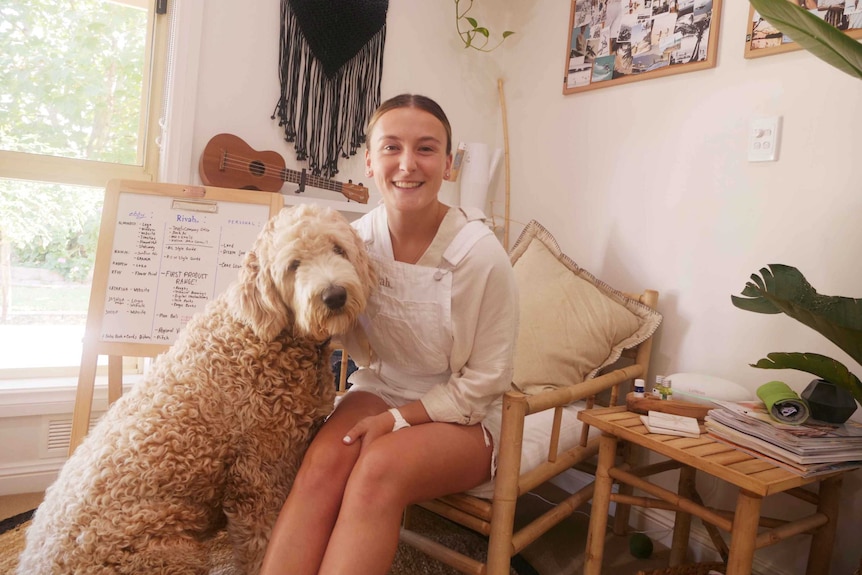 Ebony Forsyth with her dog sitting in her office.