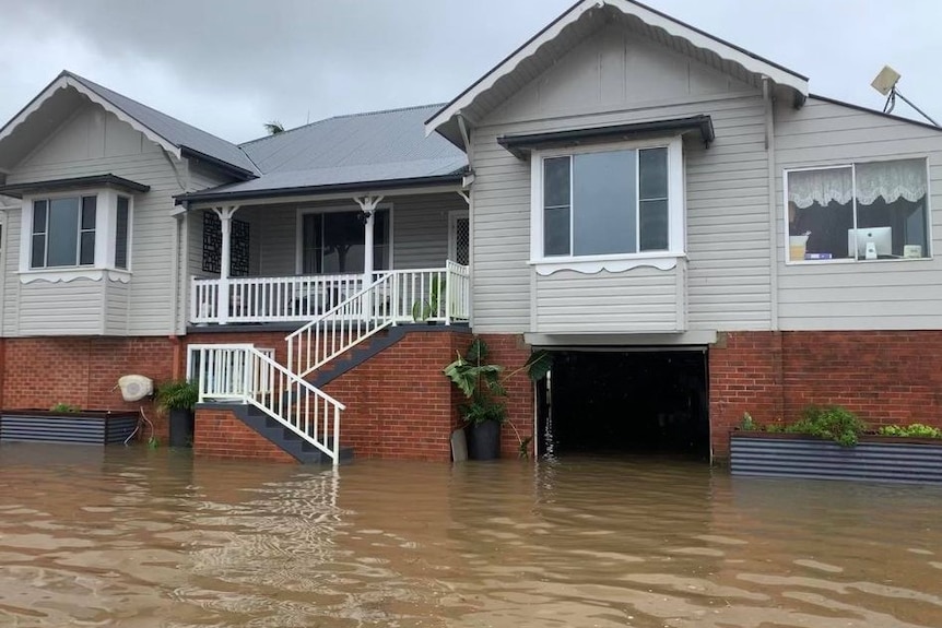 Floodwaters around the front of a house.