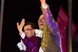 Two men wave during the Sydney Mardis Gras.