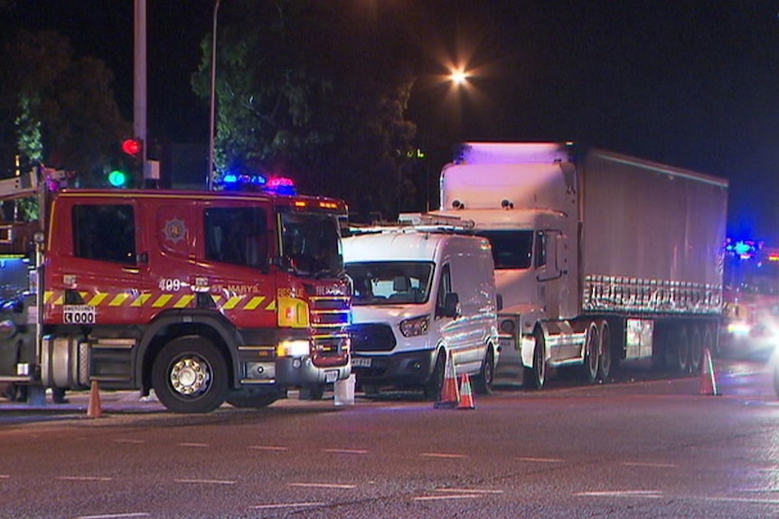 A fire truck, a van and a semi-trailer on a road