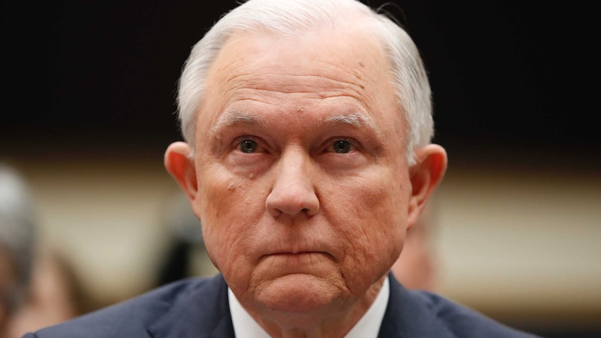 A head and shoulders shot of Attorney-General Jeff Sessions listening.