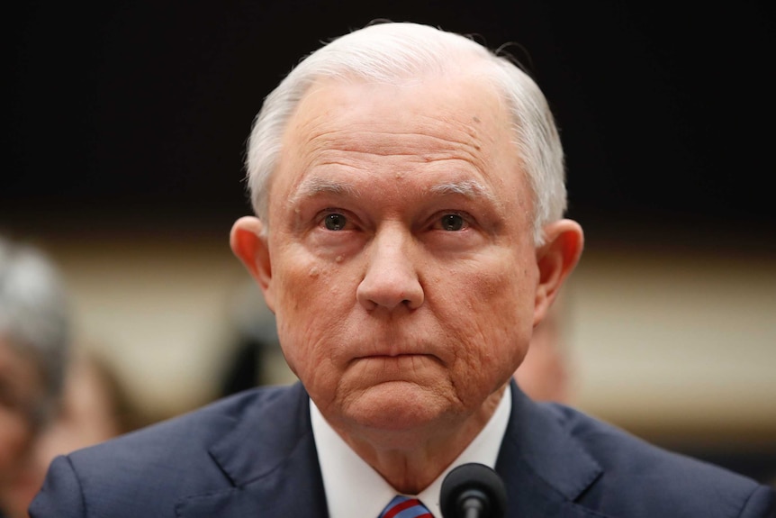 A head and shoulders shot of Attorney-General Jeff Sessions listening.
