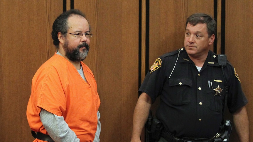 Ariel Castro (L), 53, enters the courtroom in Cleveland, Ohio July 26, 2013. Accused Cleveland kidna