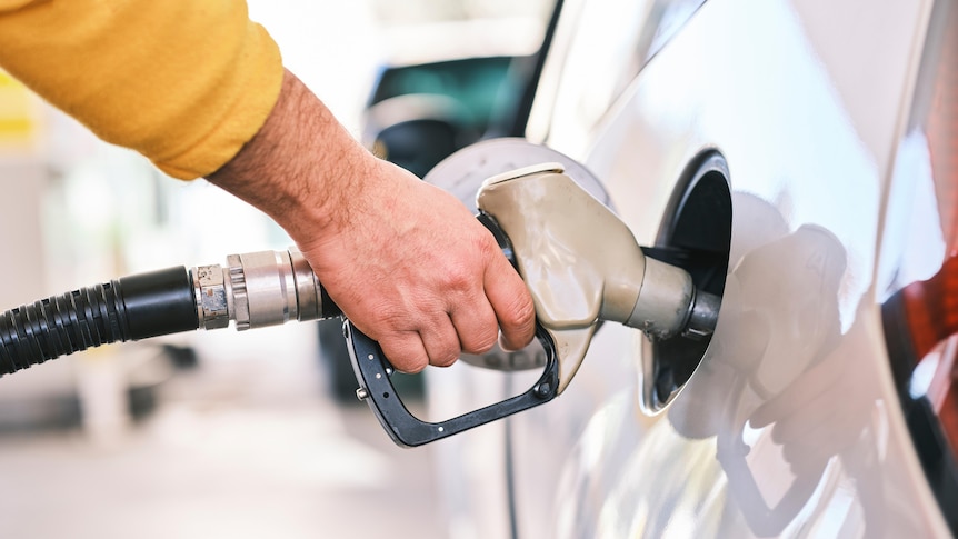 A man filling up his car with petrol.