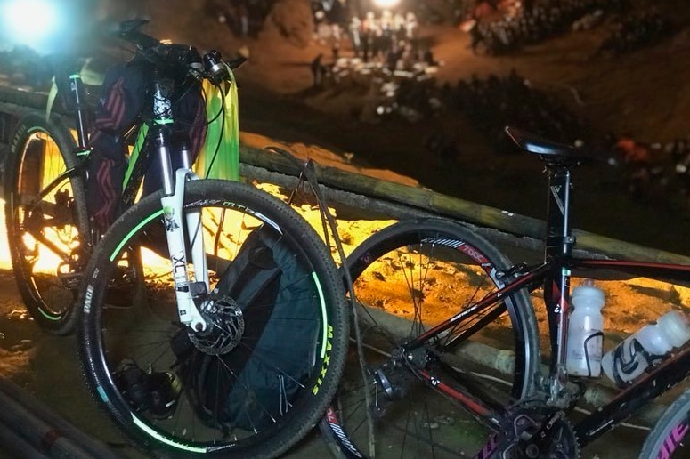 Bicycles left by a group of boys and their coach who went missing line the entrance to a cave in northern Thailand