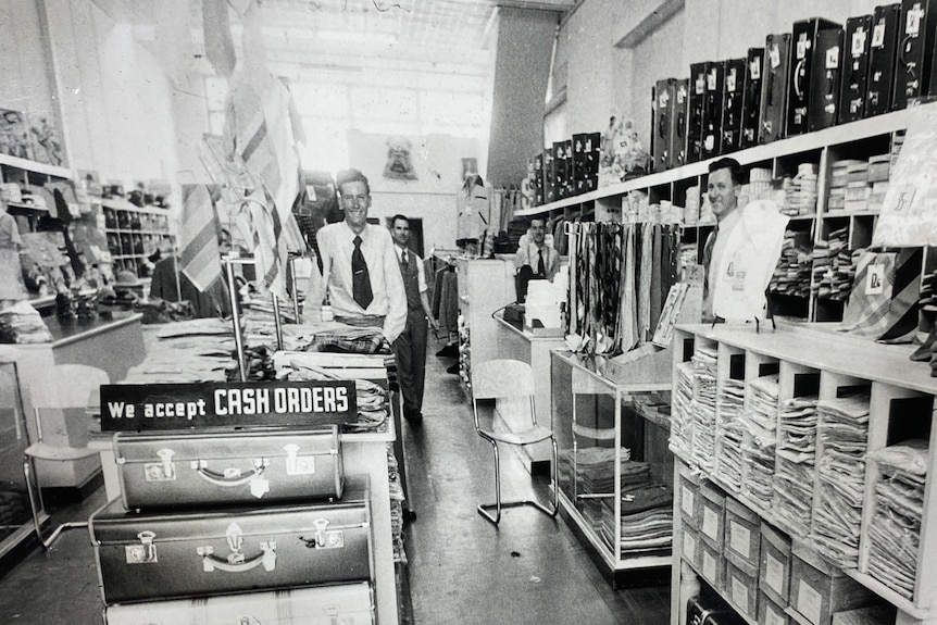 Black and white image of people in a retail store