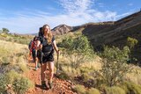 A woman leads hikers through the outback