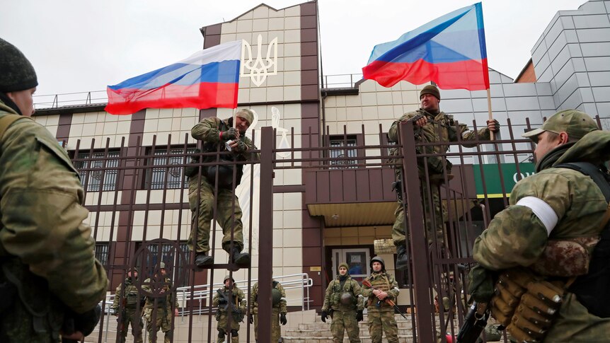 Pro-Russia milita hoist flags of Russia in Luhansk.