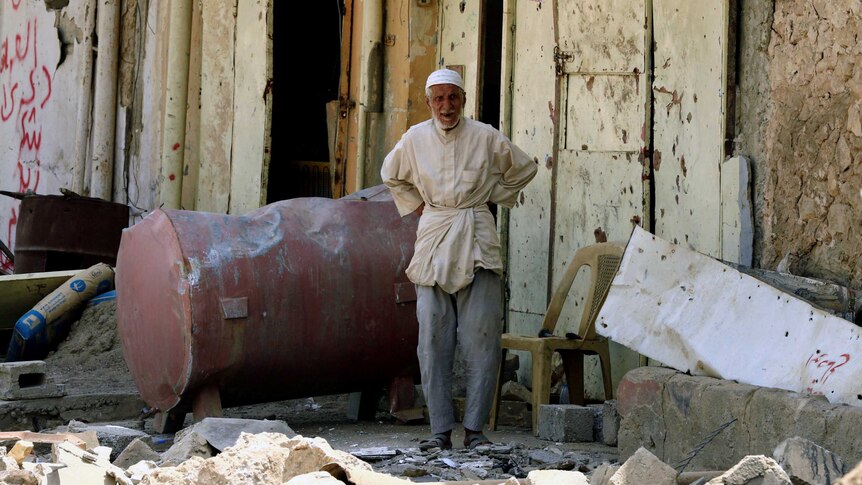 A civilian looks on from his home destroyed by clashes in the Old City of Mosul.