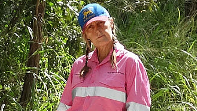 A woman in high-vis pink mining shirt