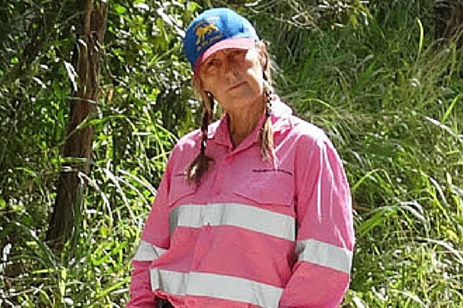 A woman in high-vis pink mining shirt