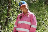 A woman in high-vis pink mining shirt