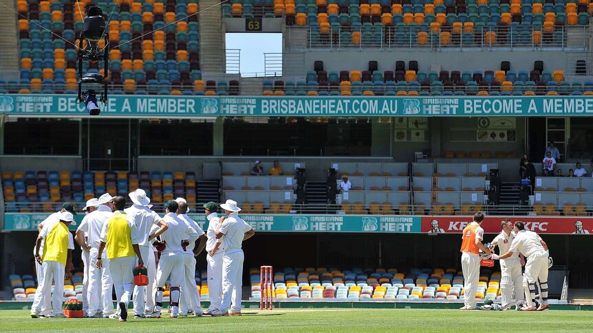 South African cricket team (left) have drinks and Australian batsmen Michael Clarke and Mike Hussey have drinks