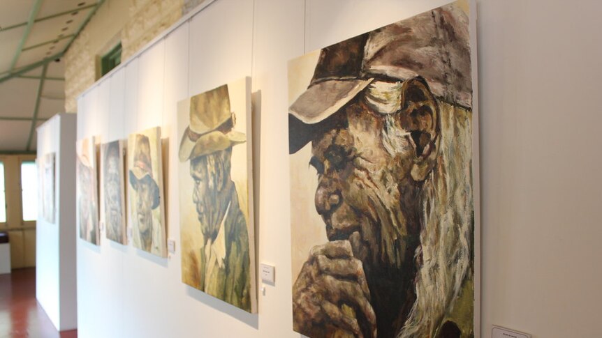 Artwork of an aboriginal man and his stockman's hat followed by a row of similar paintings