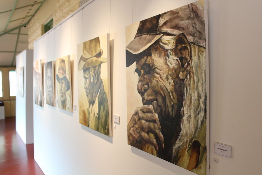 Artwork of an aboriginal man and his stockman's hat followed by a row of similar paintings