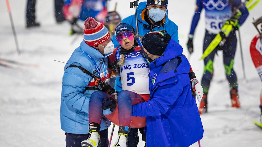 Norwegian Ingrid Landmark Tandrevold getting carried off after finishing the women´s biathlon pursuit during the Olympics 