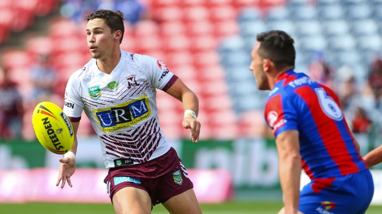A man looks to pass during a rugby league match