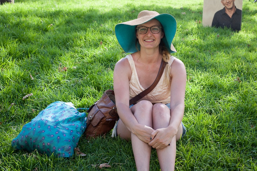 Claire McNamara sits on the grass at Adelaide Writers' Week