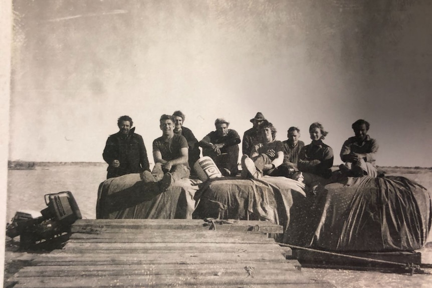 An old black and white photo of a shearing team.