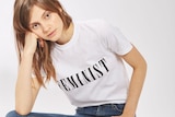 A white t-shirt with the word "Feminist" written across the front.