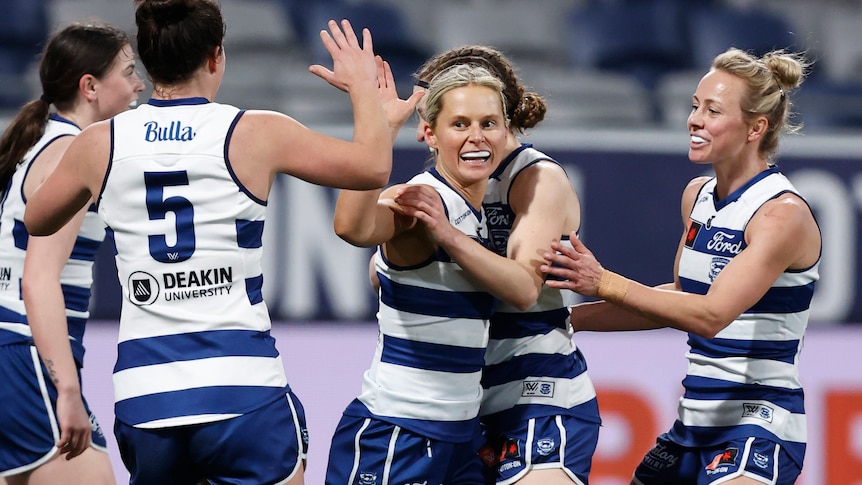 Kate Surman is congratulated by her Geelong teammates after kicking a goal in round one of AFLW 2023