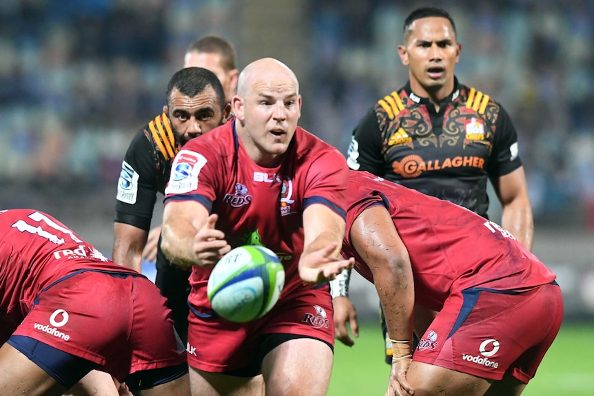 Stephen Moore passes the ball from the half-back position for Queensland Reds.