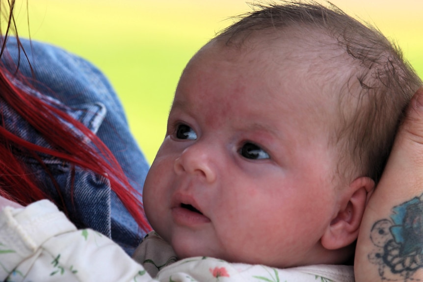 A close-up of the small baby's face