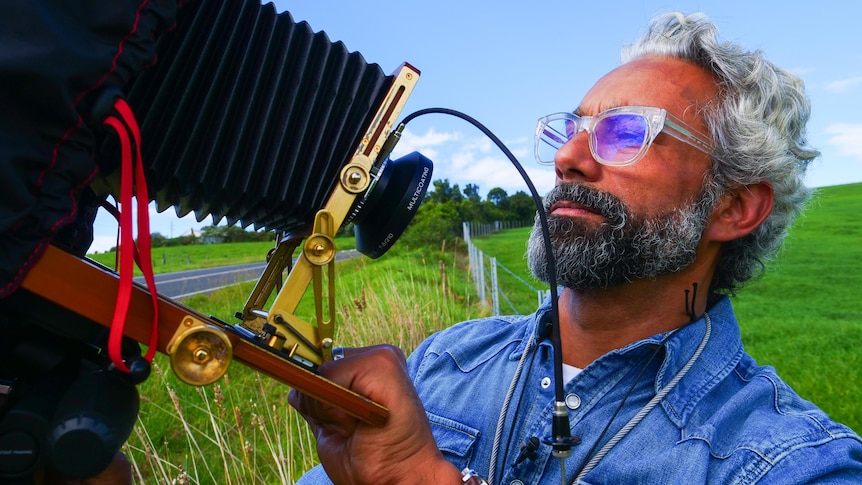 A man looking at his field camera