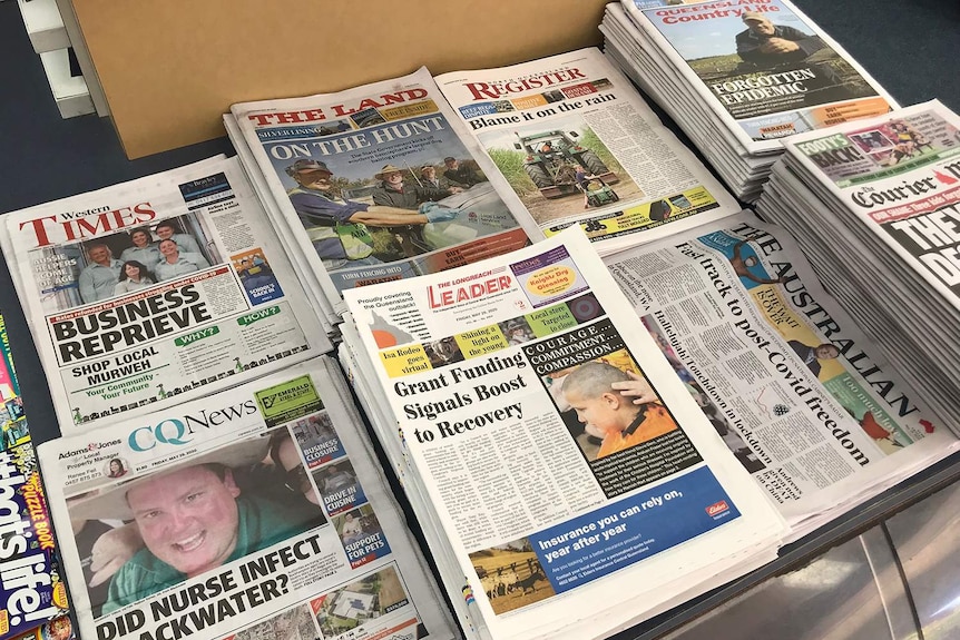 The Longreach Leader sits tall among other paper on the stand