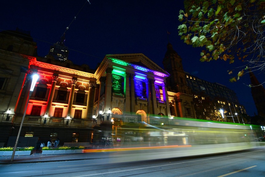 Melbourne Town Hall lights up in rainbow colours.