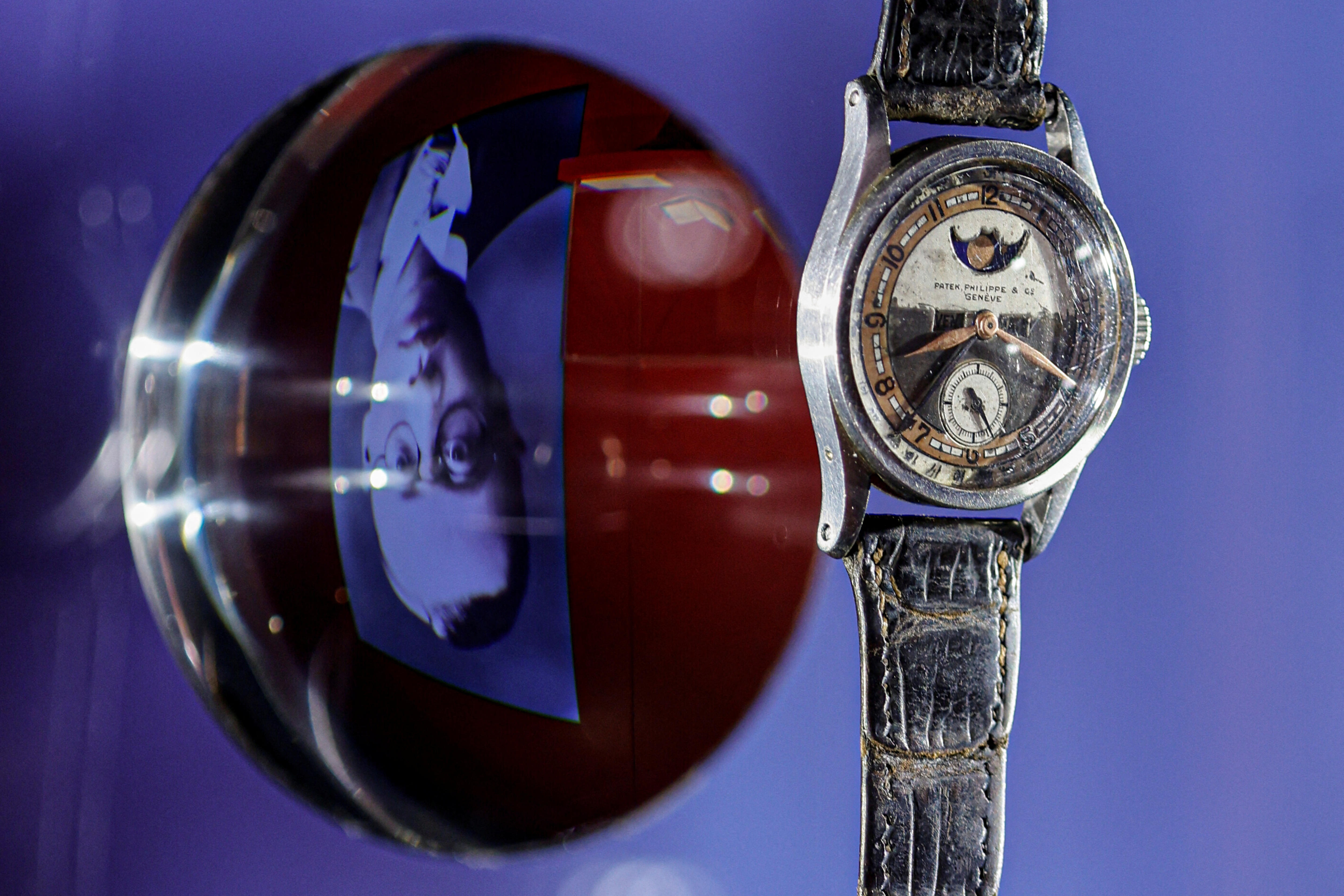 On the left a magnified photography of the emperor on the right is the watch
