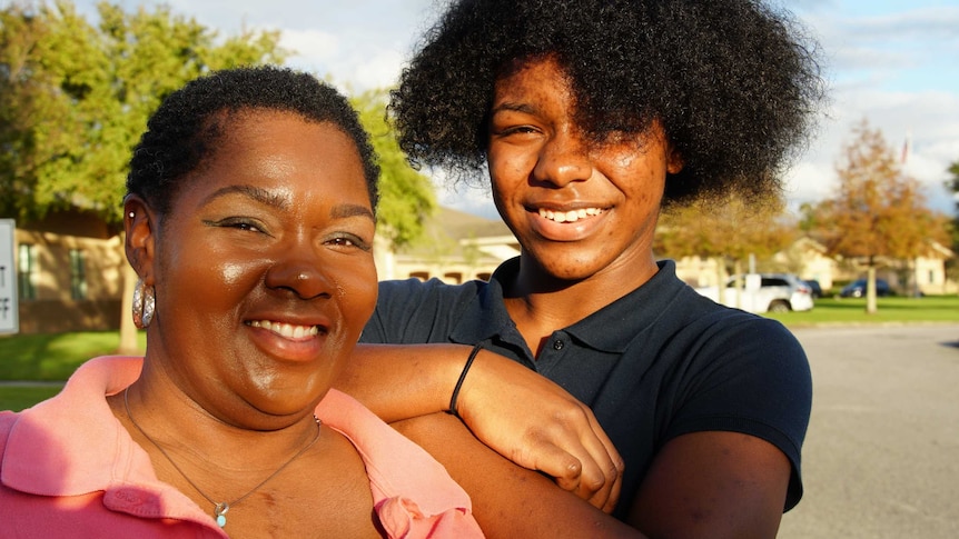 A mother and daughter smile