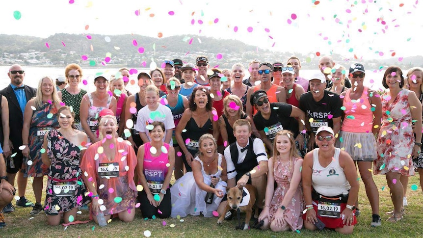 A group of people celebrating a wedding.