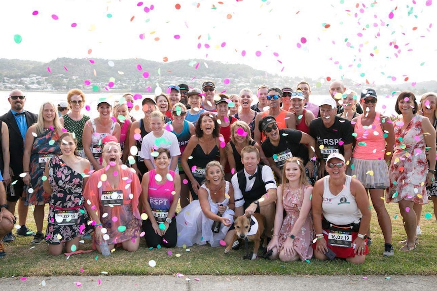 A group of people celebrating a wedding.