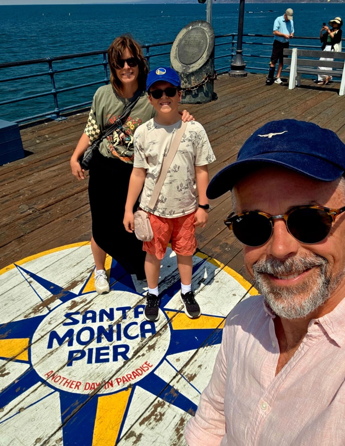 A woman stands with her son. 