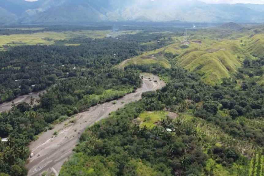 Aerial view of green rolling hills and trees. 