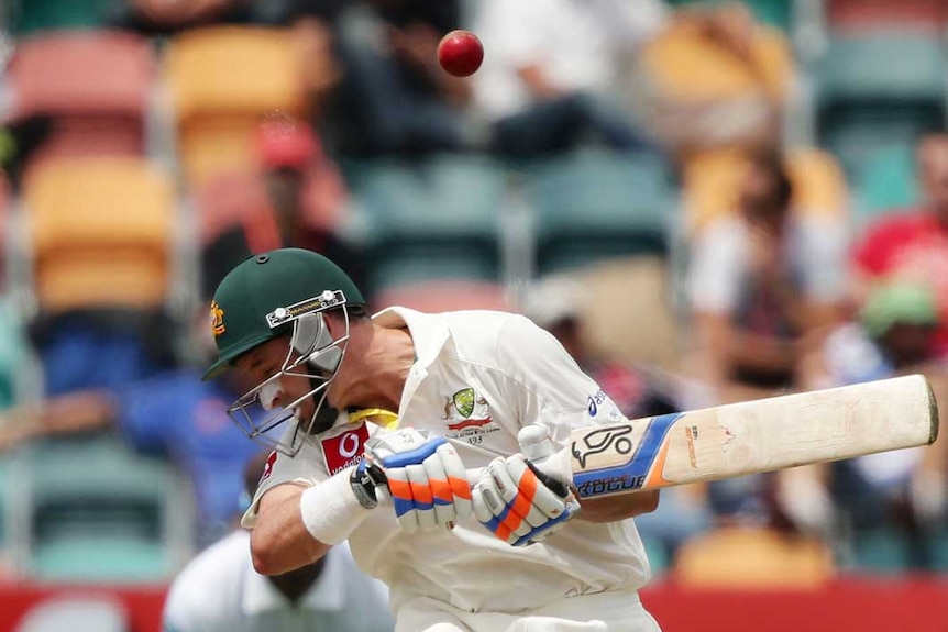 Evasive action... Mike Hussey ducks under a bouncer.