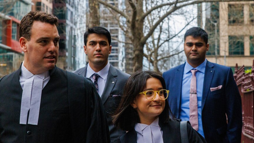 Obaid and Sheheryer Khan with their lawyers outside the Victorian County Court.