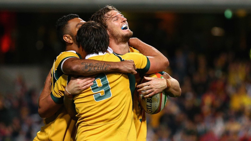 Late effort ... Rob Horne (R) celebrates with team-mates after scoring his try